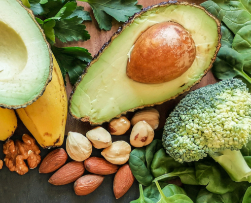 a colourful image of vegetables, fruit and nuts that are all high in magnesium
