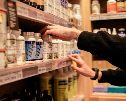 Brooke stocking the Wellness shelves
